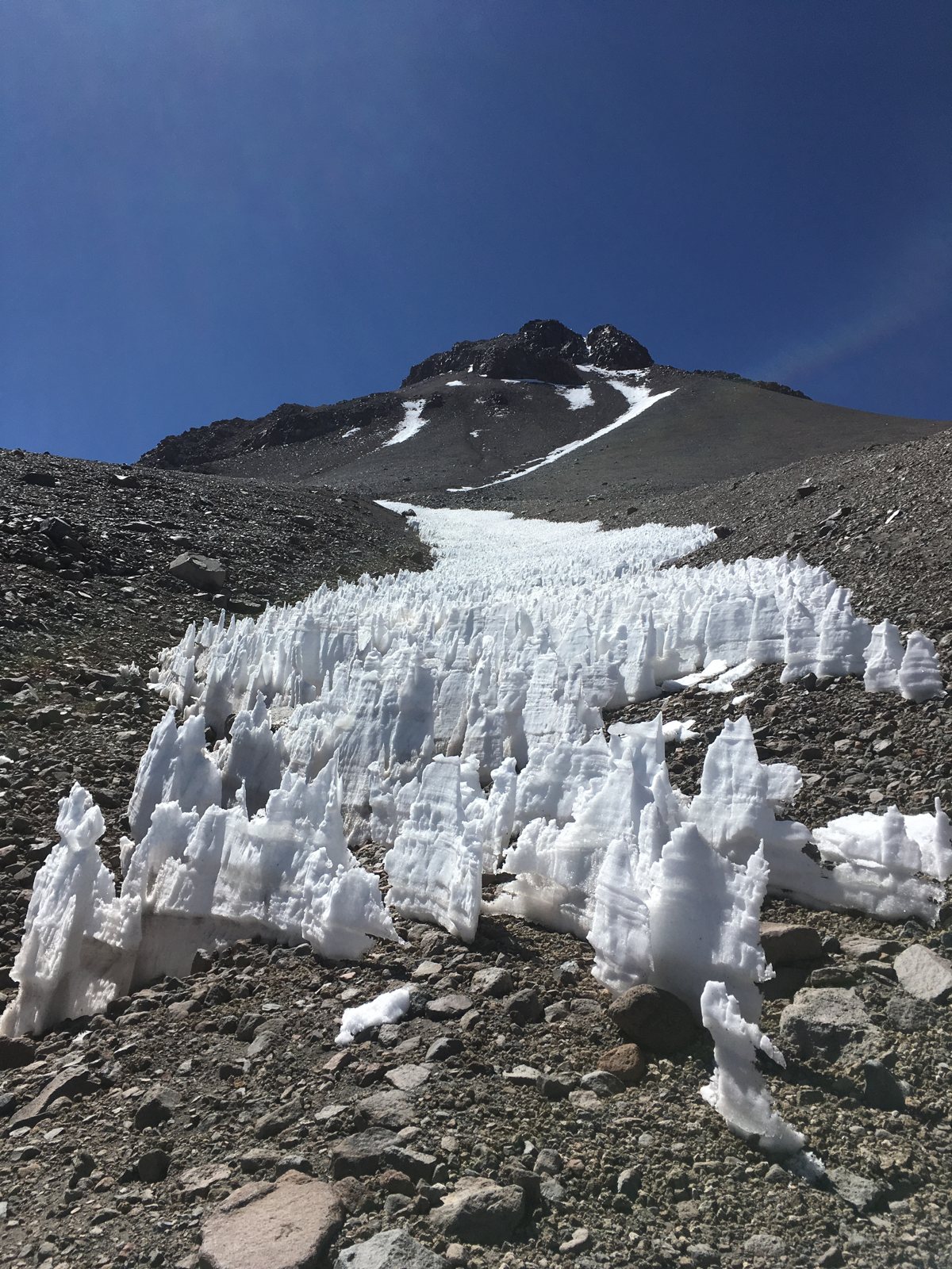Close view of penitentes ice blades on a rocky slope