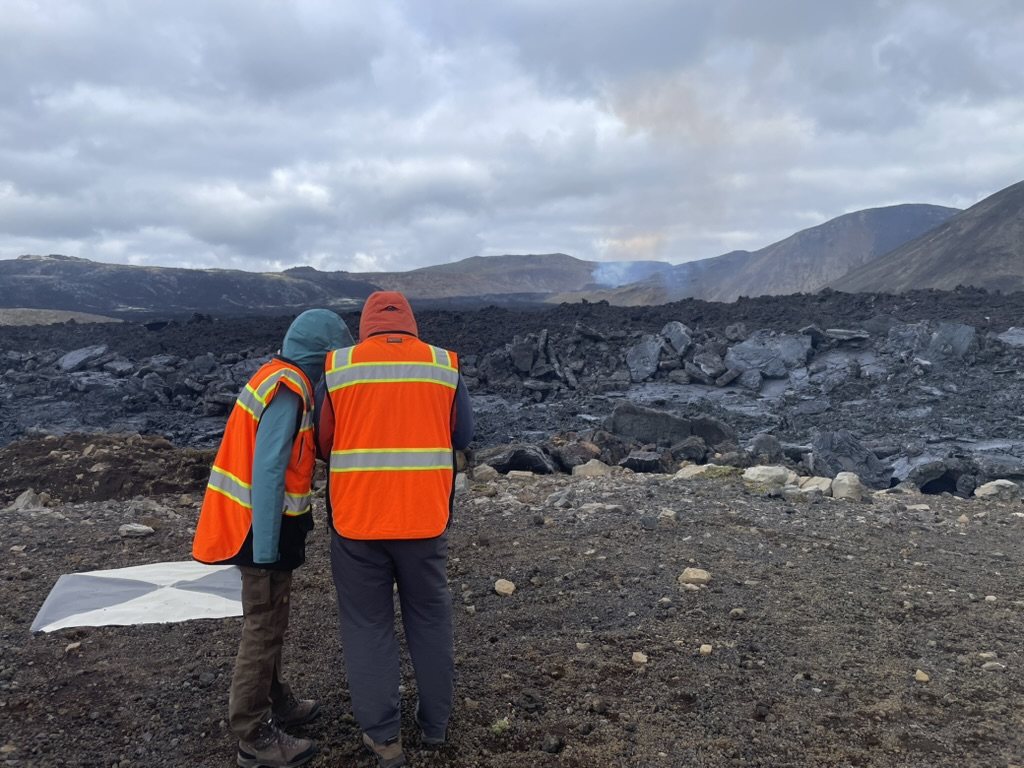 Two people in orange hi-vis vests on the new lava field