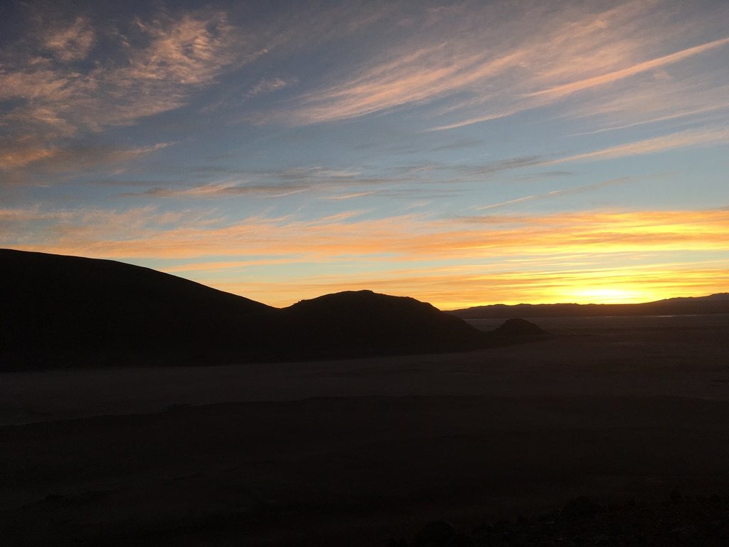Orange sunset behind dark ridgelines